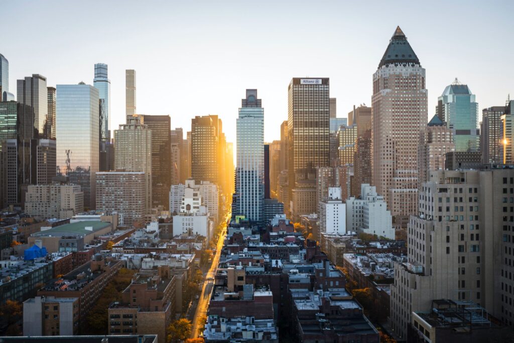 Cityscape with tall skyscrapers and a street running through the center.