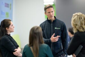 Bradley McCloskey speaks with healthcare providers during MediVera’s grand opening event in Troy.